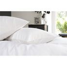 Two pillows on a bed with 400 thread count Egyptian Cotton pillowcases