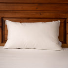 White Duck Down Pillow with a wooden headboard