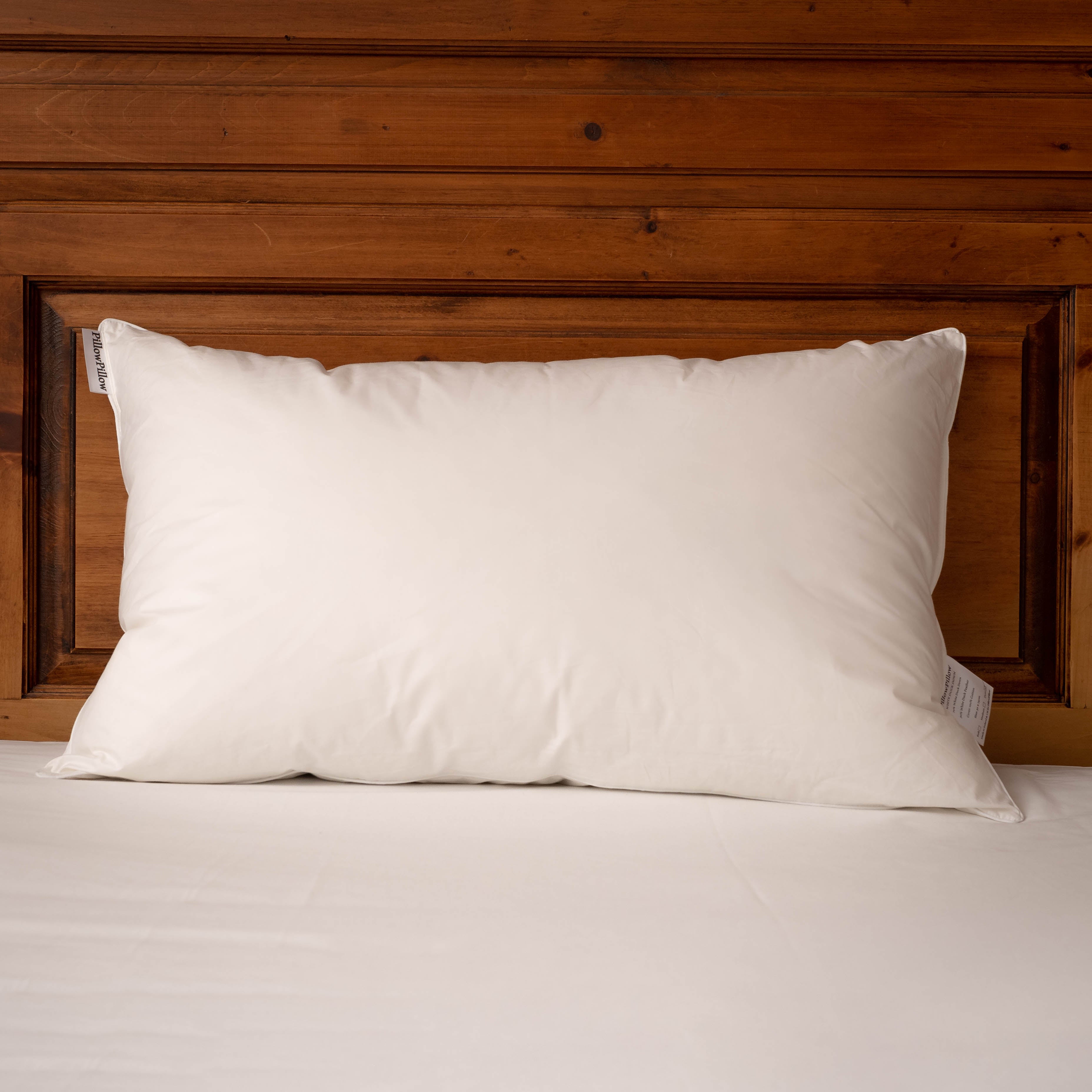 White Duck Down Pillow with a wooden headboard