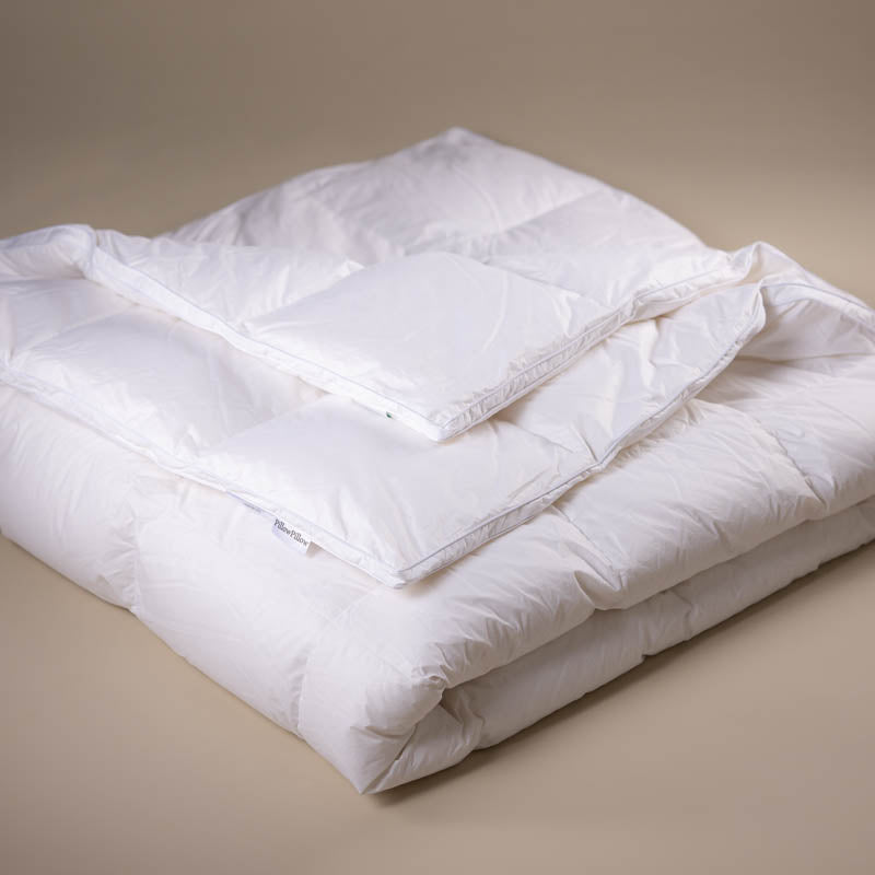 Pure White Siberian Goose Down Duvet folded into a square on a neutral background