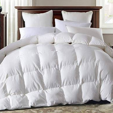Warm plump Super King size White Goose Down Duvet on a bed with lots of pillows
