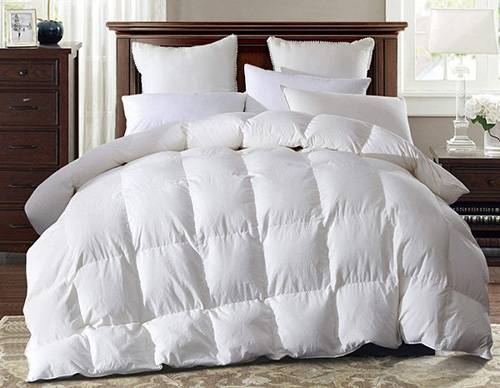 Warm plump Super King size White Goose Down Duvet on a bed with lots of pillows