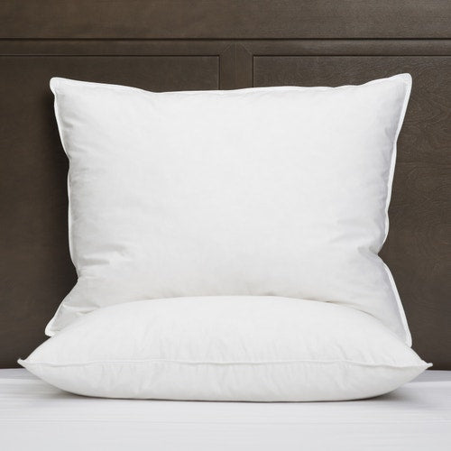 Two Big Square pillows with dark wooden headboard