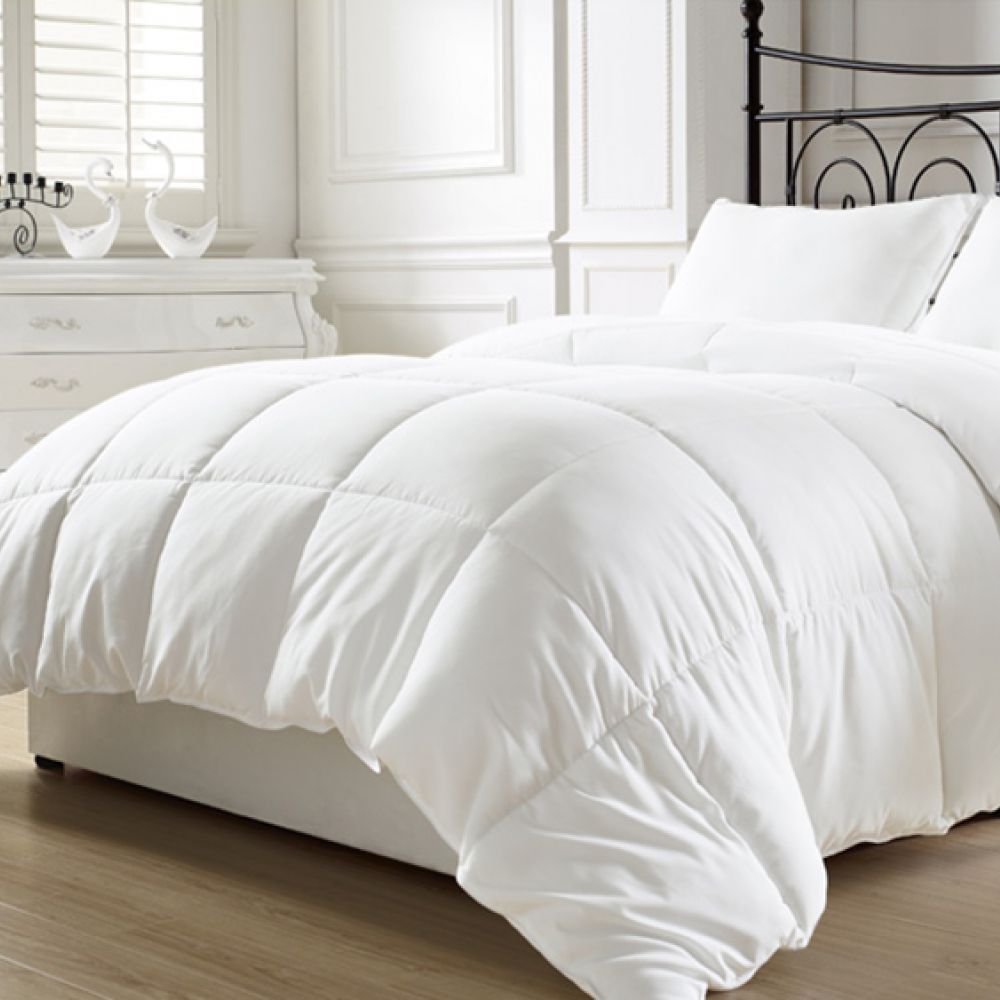 Siberian Goose down Duvet on a double bed with iron headboard