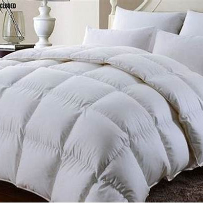 White Goose Down Duvet on a bed with four plump pillows